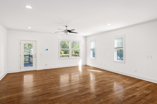 unfurnished living room with ceiling fan, crown molding, and dark wood-type flooring