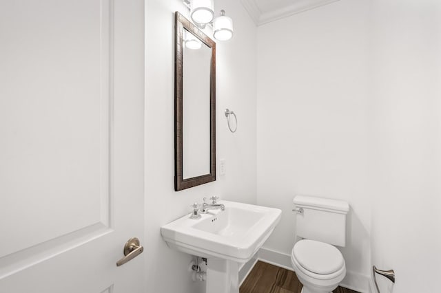 bathroom with ornamental molding, hardwood / wood-style floors, sink, and toilet