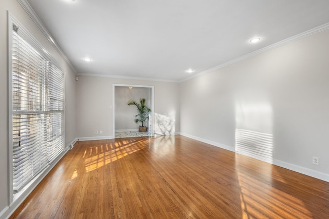 spare room featuring hardwood / wood-style floors and crown molding