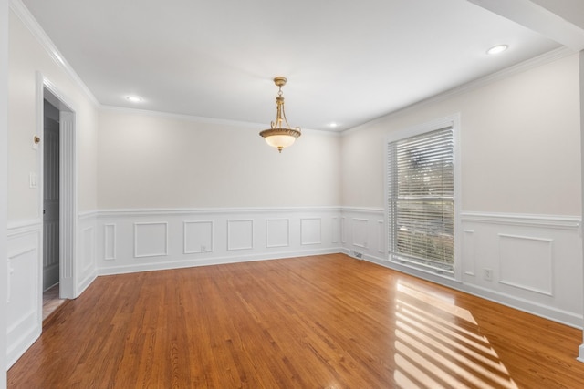 unfurnished room with hardwood / wood-style flooring and ornamental molding