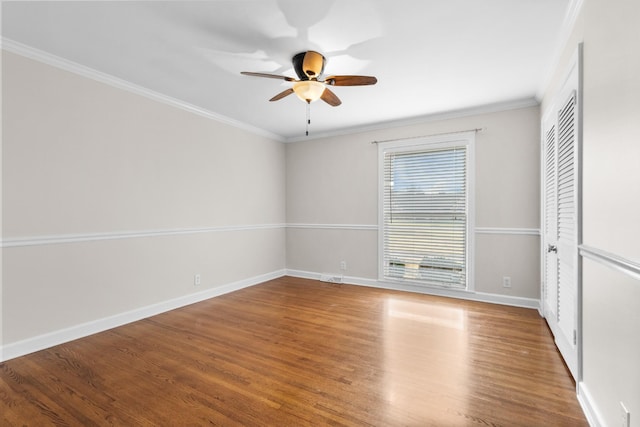 unfurnished room featuring ceiling fan, ornamental molding, and hardwood / wood-style floors