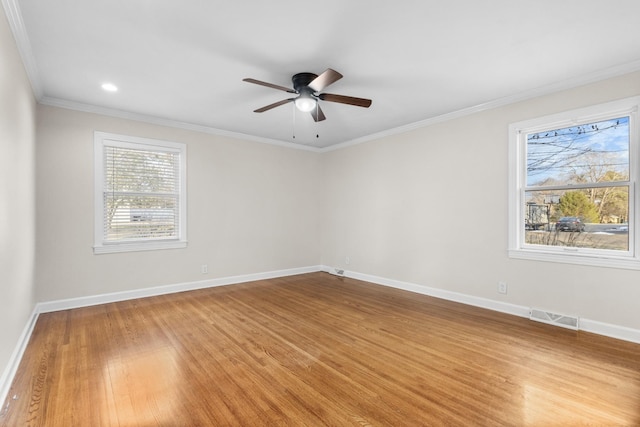 unfurnished room with hardwood / wood-style flooring, ceiling fan, and crown molding