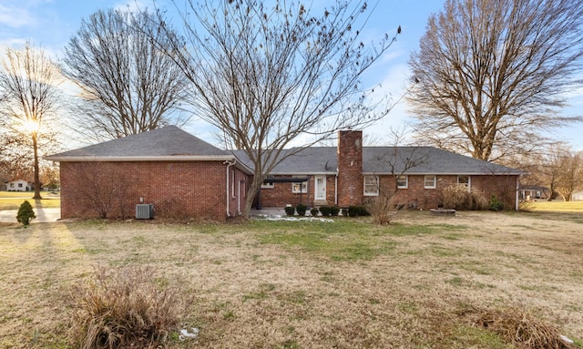 back of property with cooling unit and a yard