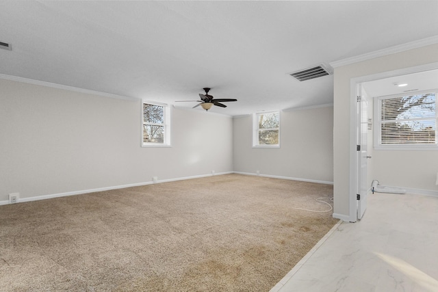 spare room featuring ceiling fan, ornamental molding, and light carpet