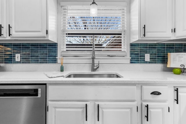 kitchen featuring white cabinets, hanging light fixtures, dishwasher, and sink