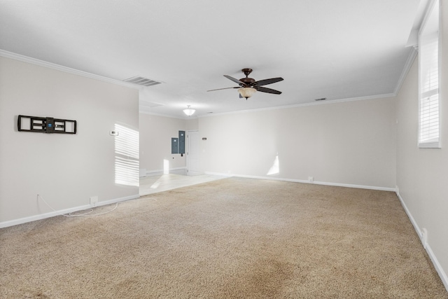 empty room with ornamental molding, ceiling fan, a healthy amount of sunlight, and carpet