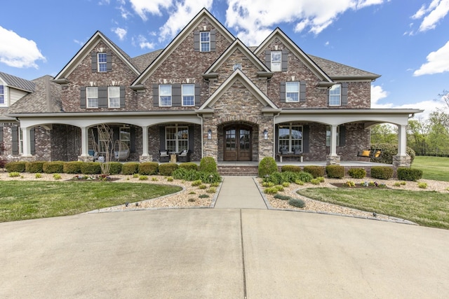 craftsman house featuring a porch, french doors, and a front yard