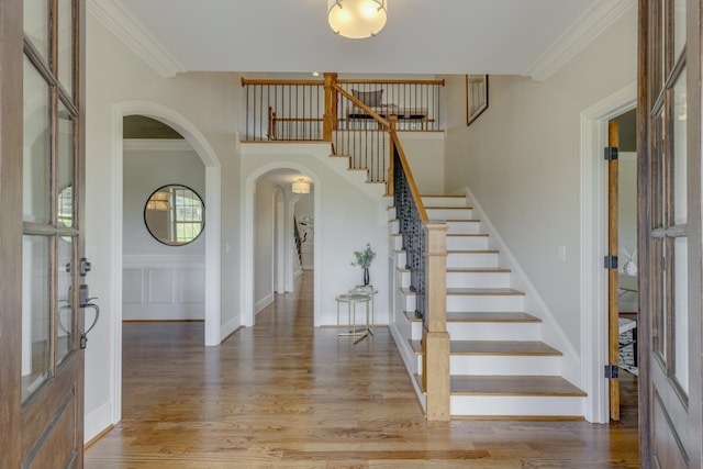 entrance foyer featuring ornamental molding and wood-type flooring