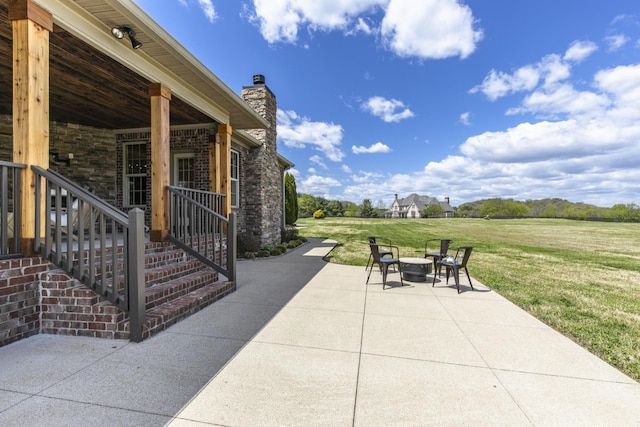 view of patio with an outdoor fire pit