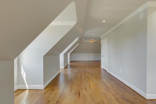 bonus room with light hardwood / wood-style flooring and vaulted ceiling