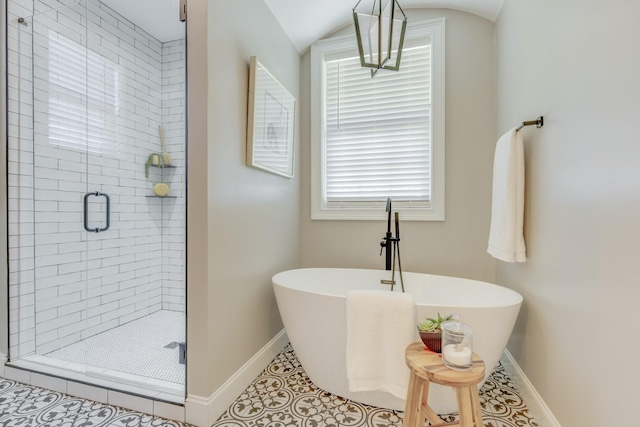 bathroom with shower with separate bathtub, tile patterned floors, and vaulted ceiling