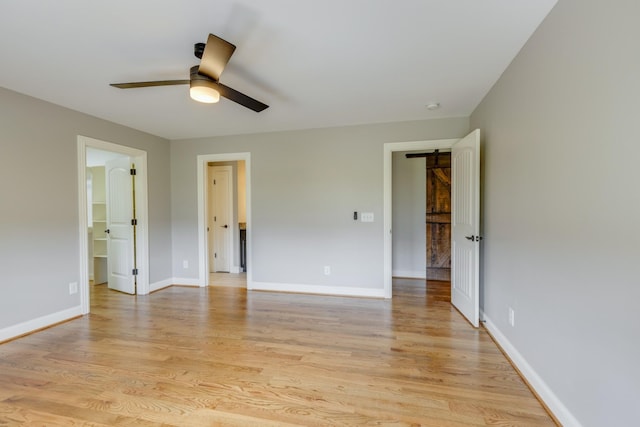 empty room with light wood-type flooring and ceiling fan