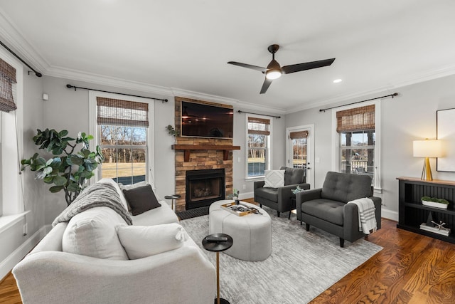 living room with a fireplace, ceiling fan, crown molding, and dark hardwood / wood-style floors