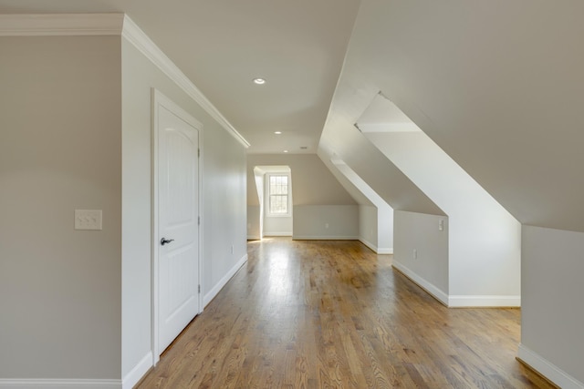 bonus room featuring light wood-type flooring and vaulted ceiling