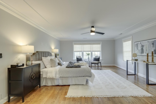 bedroom featuring ceiling fan, light hardwood / wood-style flooring, and ornamental molding