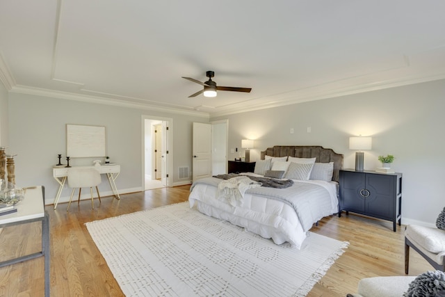 bedroom featuring ceiling fan, crown molding, and light hardwood / wood-style floors