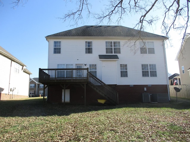 back of house with a deck, central air condition unit, and a yard