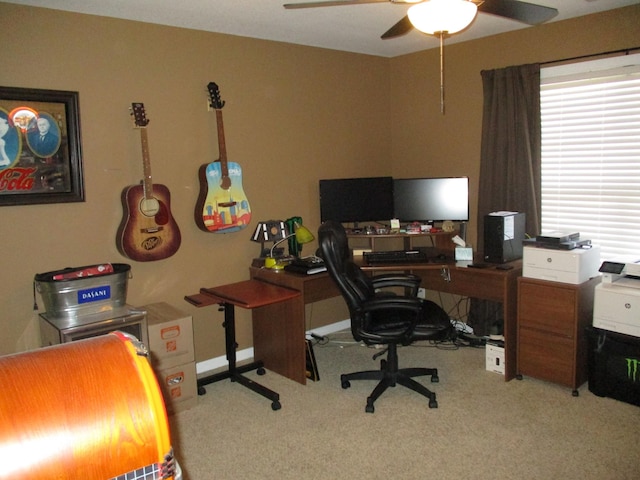 carpeted office space featuring ceiling fan