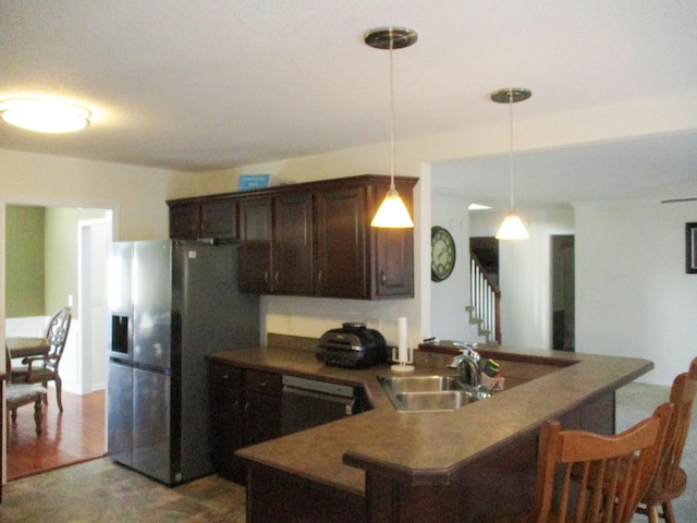 kitchen with pendant lighting, sink, dark brown cabinetry, stainless steel fridge with ice dispenser, and dishwashing machine