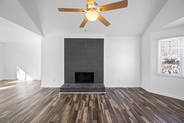 unfurnished living room featuring a brick fireplace, ceiling fan, vaulted ceiling, and dark hardwood / wood-style floors