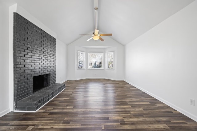 unfurnished living room with ceiling fan, dark hardwood / wood-style flooring, a brick fireplace, and lofted ceiling with beams