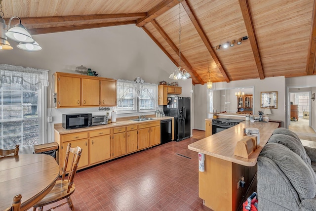 kitchen featuring a notable chandelier, decorative light fixtures, kitchen peninsula, and black appliances