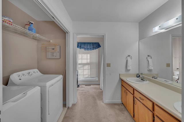 bathroom featuring vanity and washing machine and clothes dryer