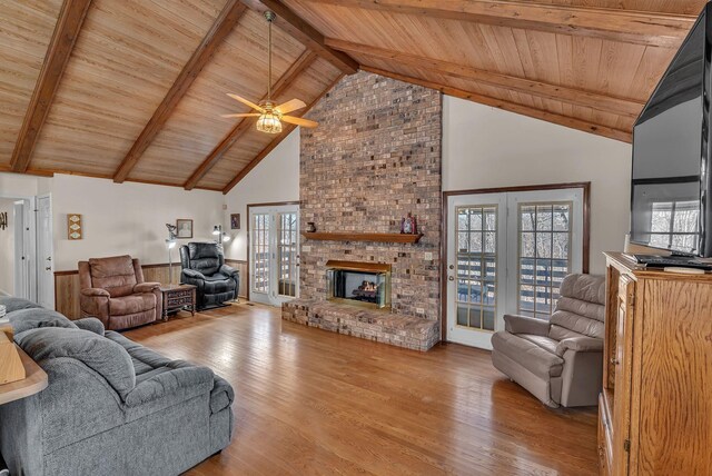 living room featuring wood ceiling, high vaulted ceiling, beamed ceiling, and light wood-type flooring