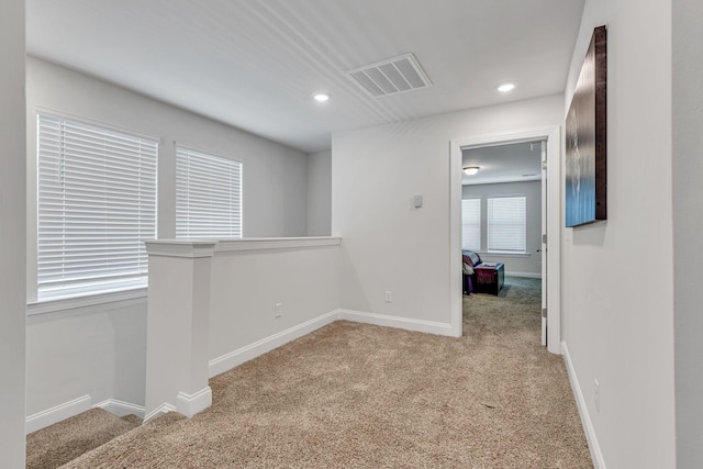 hallway with light colored carpet