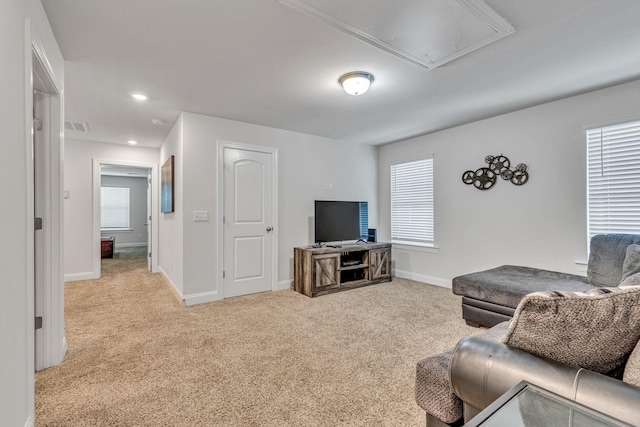 living room featuring a healthy amount of sunlight and light colored carpet