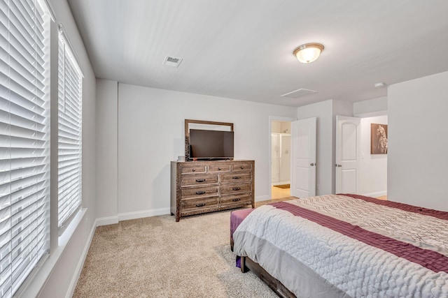 bedroom with light carpet and multiple windows