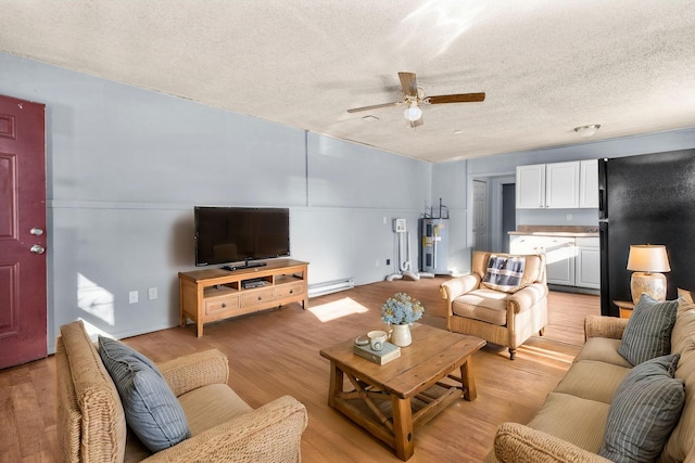 living room with water heater, a baseboard heating unit, a textured ceiling, and light hardwood / wood-style flooring