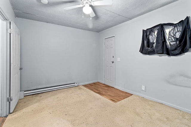 carpeted empty room with a baseboard heating unit, a textured ceiling, and ceiling fan