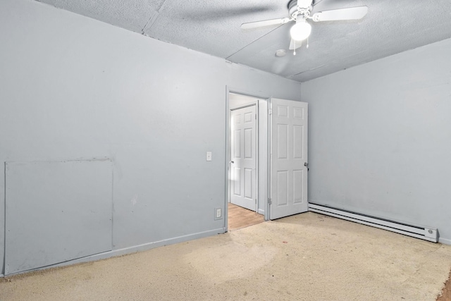 carpeted empty room with baseboard heating and ceiling fan