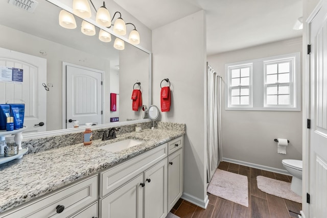 bathroom featuring toilet and vanity