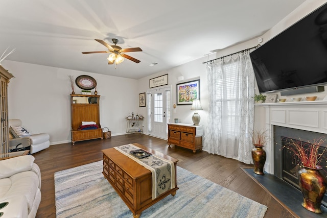 living room featuring ceiling fan and dark hardwood / wood-style flooring