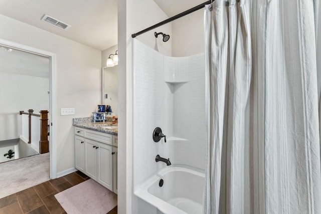 bathroom featuring shower / tub combo and vanity