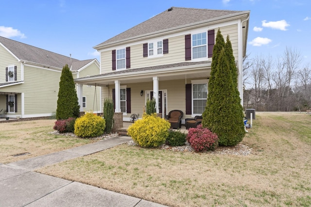 view of front of house featuring a porch, central AC, and a front lawn