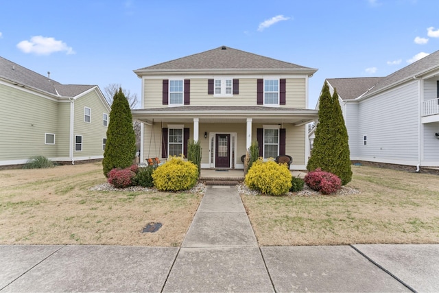 view of front of home featuring a front yard and a porch