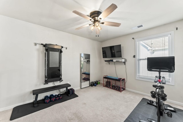 exercise room featuring ceiling fan and light colored carpet