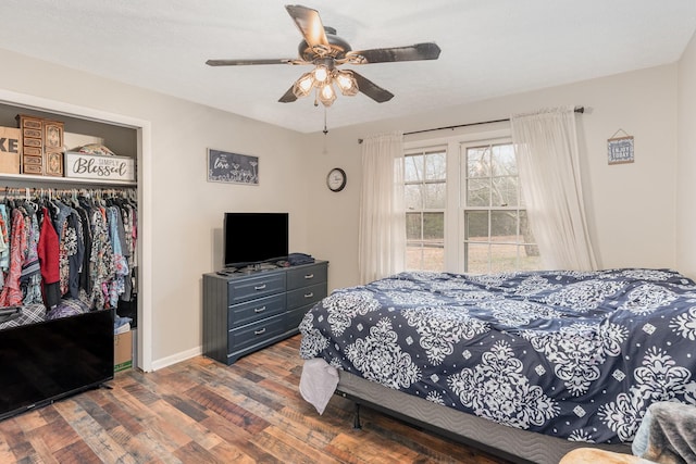 bedroom with ceiling fan, dark hardwood / wood-style flooring, and a closet