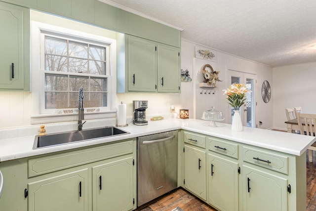 kitchen featuring hardwood / wood-style floors, stainless steel dishwasher, kitchen peninsula, sink, and a textured ceiling