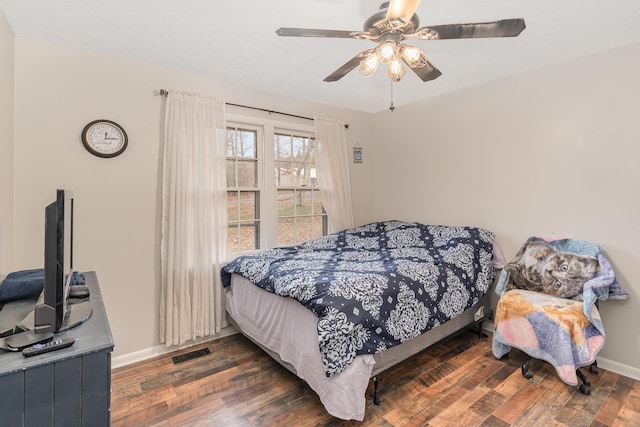 bedroom with ceiling fan and dark hardwood / wood-style floors