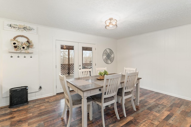 dining area with french doors, dark hardwood / wood-style floors, and a textured ceiling