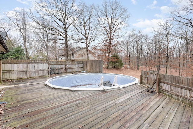 wooden terrace featuring a fenced in pool