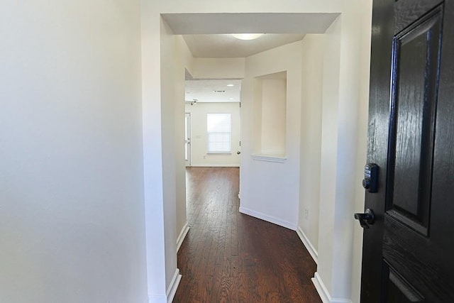 hallway featuring dark hardwood / wood-style flooring