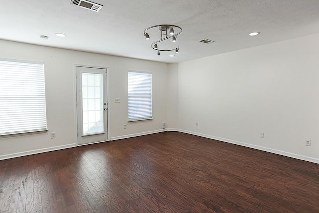 unfurnished room featuring dark hardwood / wood-style floors