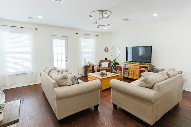 living room with plenty of natural light and dark hardwood / wood-style floors