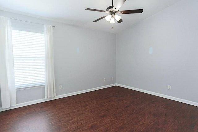 spare room with ceiling fan and dark hardwood / wood-style floors