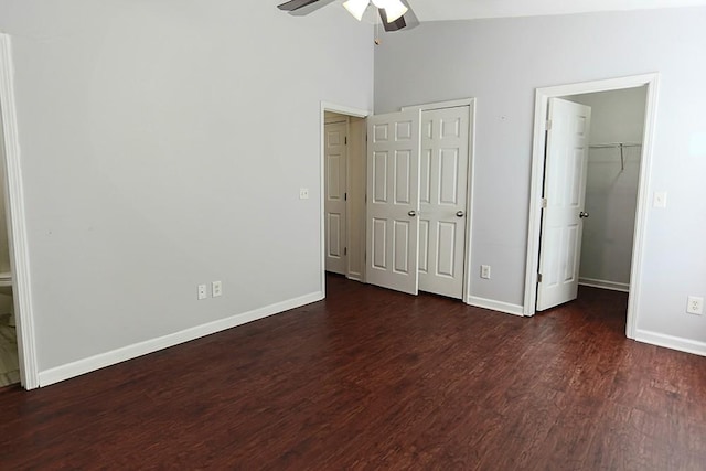 unfurnished bedroom with ceiling fan, high vaulted ceiling, and dark hardwood / wood-style floors